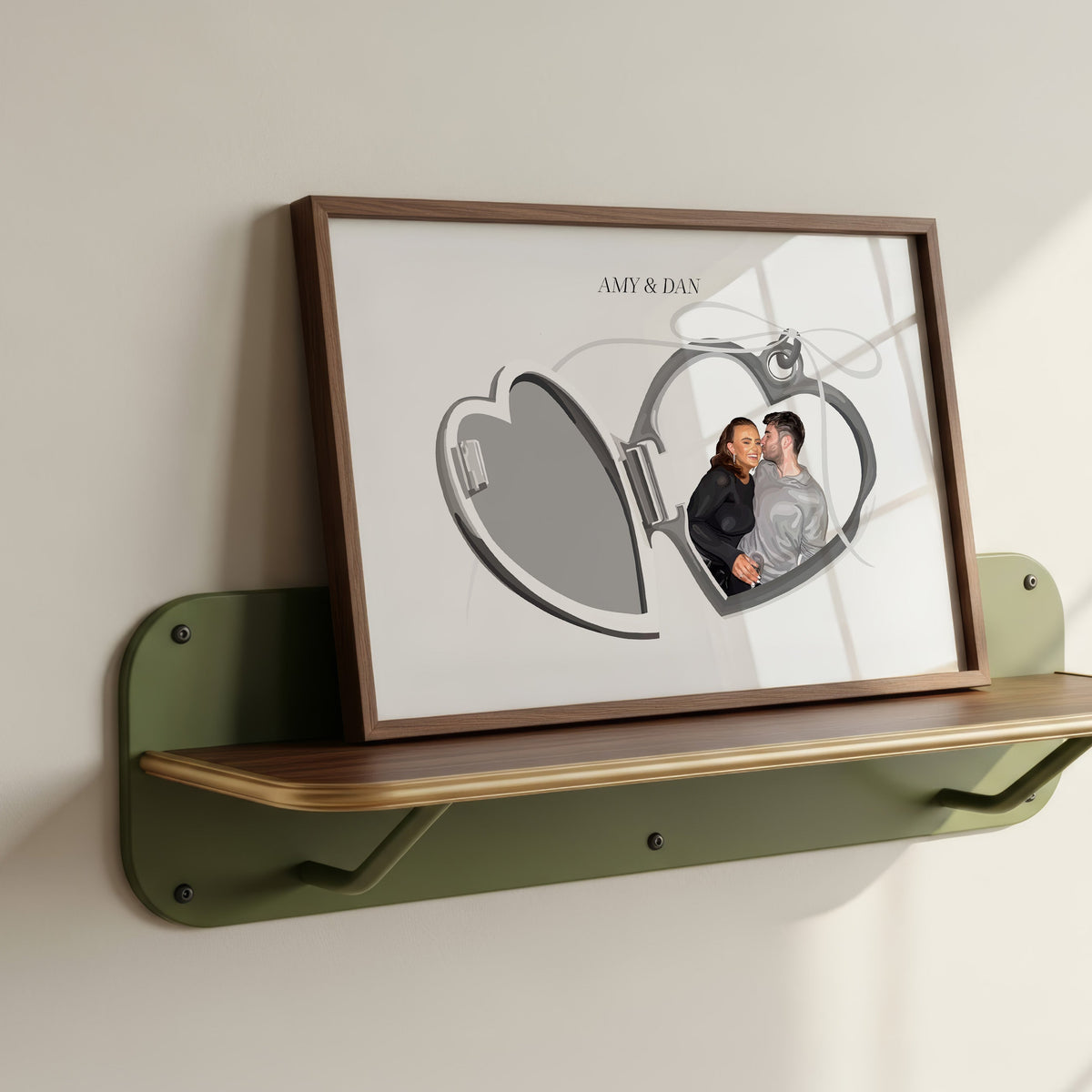 Locket Portrait of a couple Amy and Dan in a wooden frame resting on a green shelf.