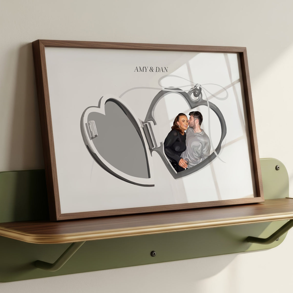 Locket Portrait of a couple Amy and Dan in a wooden frame resting on a green shelf.