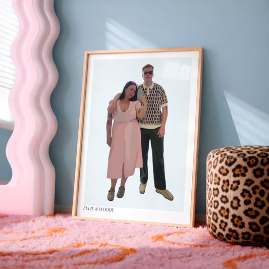A framed custom People Portrait of a couple leaning against a blue-grey wall on a pink rug, next to a pink wavy mirror and a leopard print ottoman.