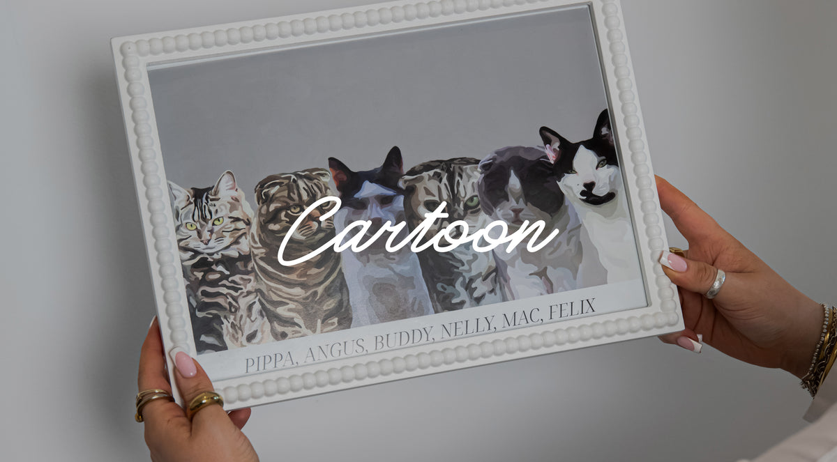 Someone holding a Cartoon Pet Portrait of 6 cats in a white textured frame against a white wall.