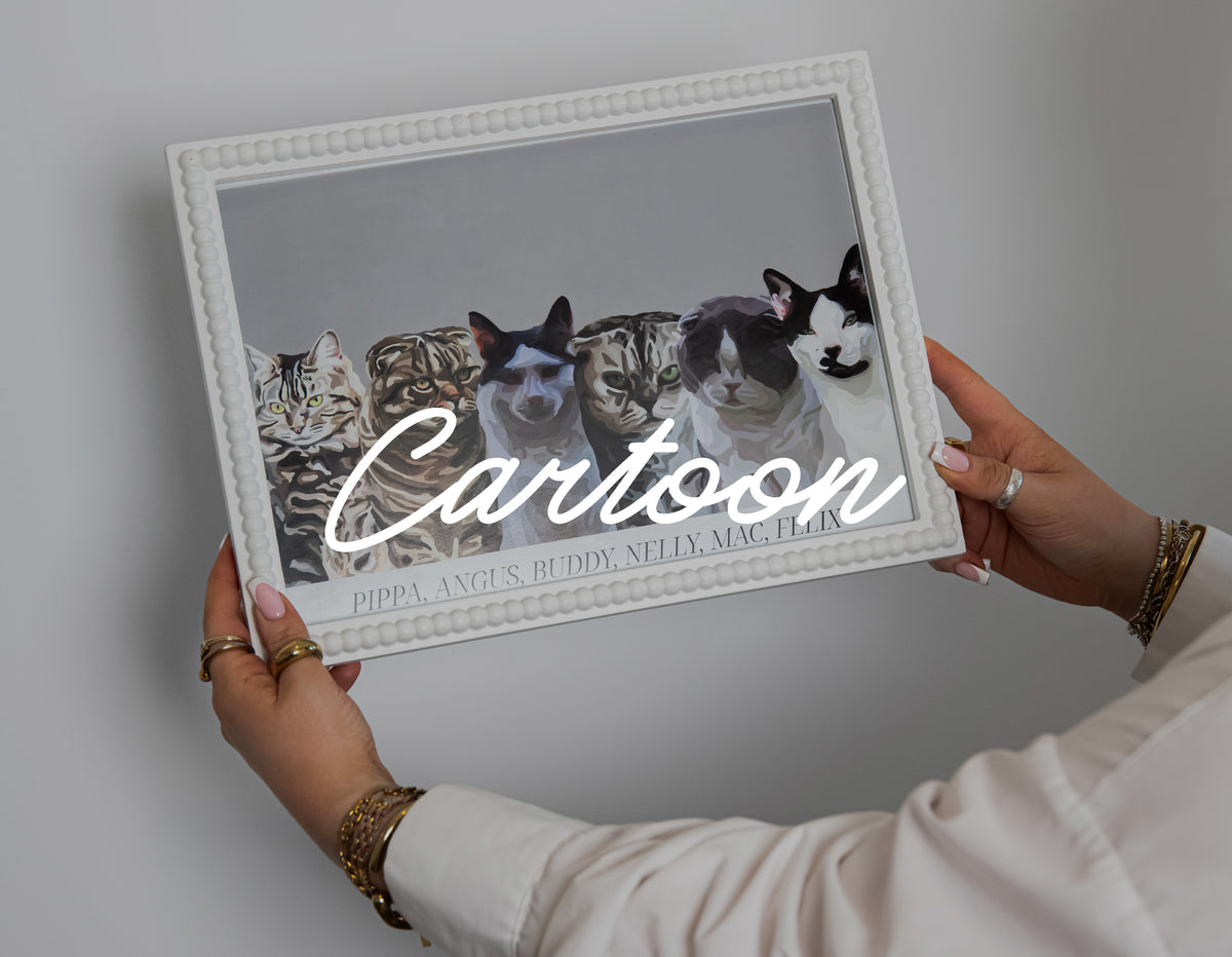 Someone holding a Cartoon Pet Portrait of 6 cats in a white textured frame against a white wall.